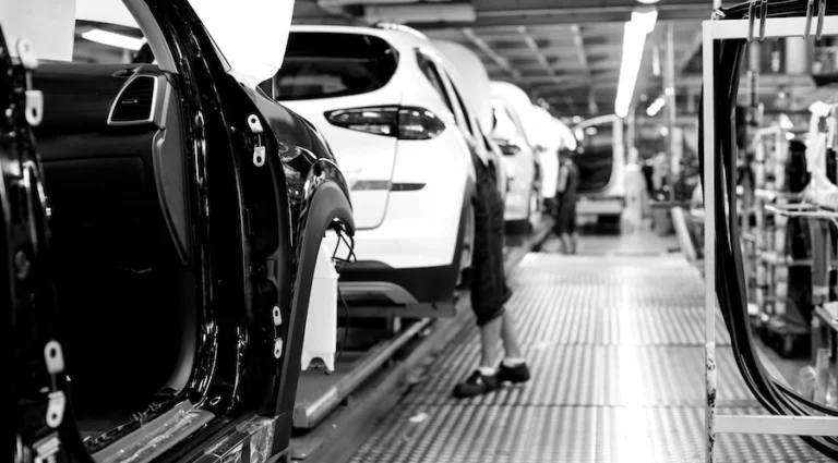 Car frames moving through an automotive manufacturing facility