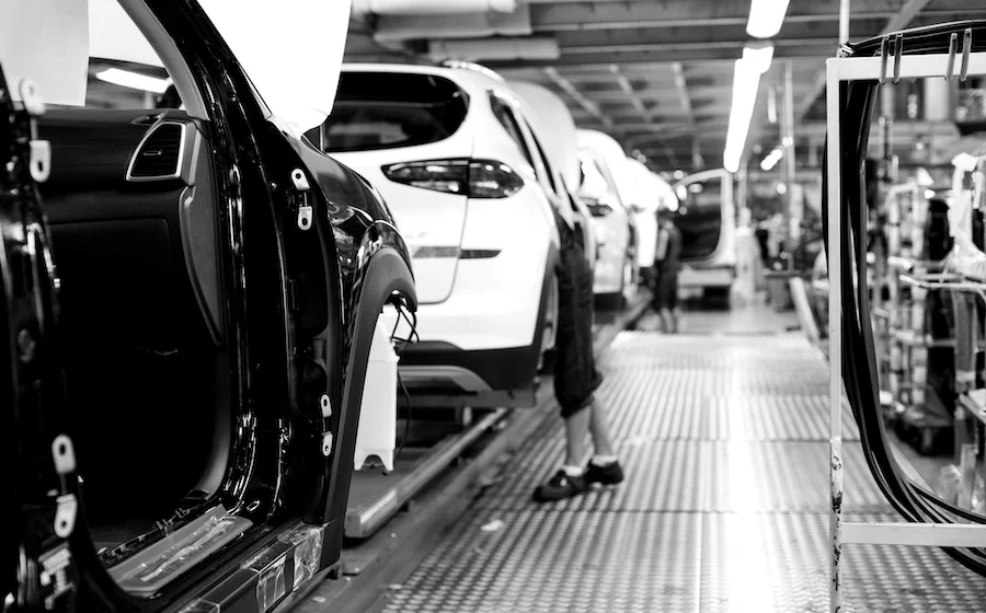 Car frames moving through an automotive manufacturing facility