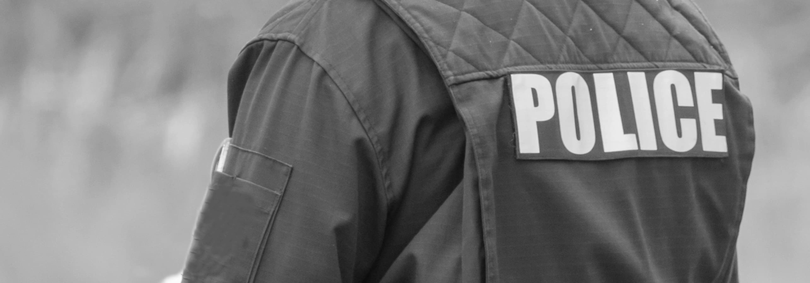 Back of a police uniform that reads "POLICE"