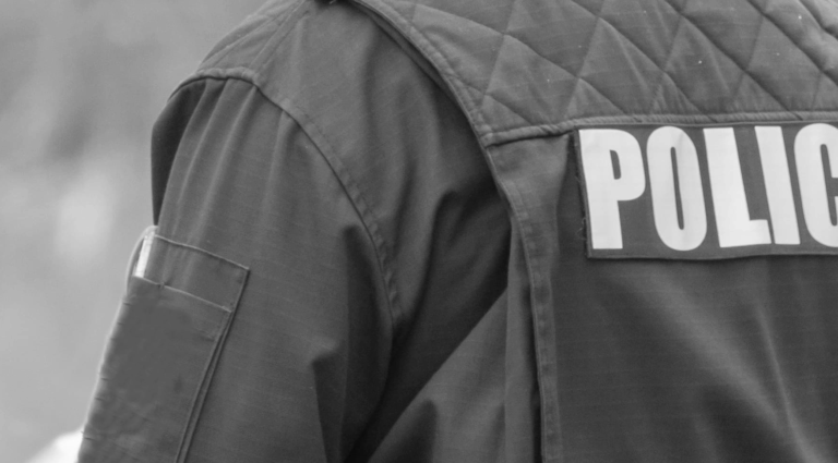 Back of a police uniform that reads "POLICE"