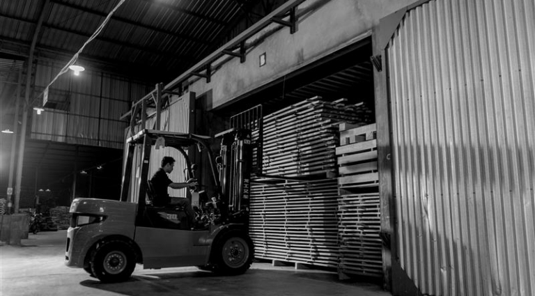 Forklift in a warehouse moving pallets