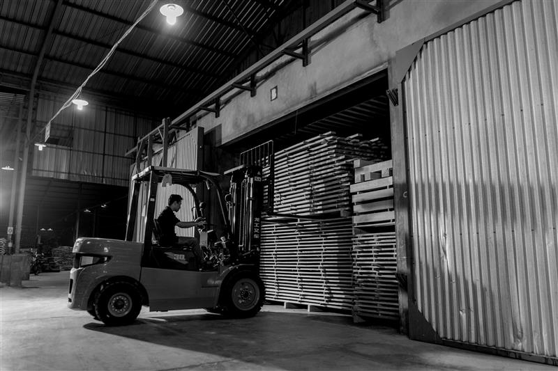 Forklift in a warehouse moving pallets