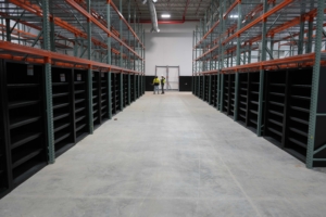 2 rows of Strong Hold closed shelving units in an industrial setting